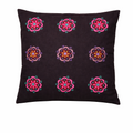 Black cushion cover featuring a symmetrical grid of nine embroidered floral motifs. Each flower is stitched in vibrant shades of pink, red, purple, teal, and yellow, creating a bright contrast against the dark fabric. The decorative folk-style embroidery gives the cushion a colourful, handcrafted look that adds warmth and character to home décor.
