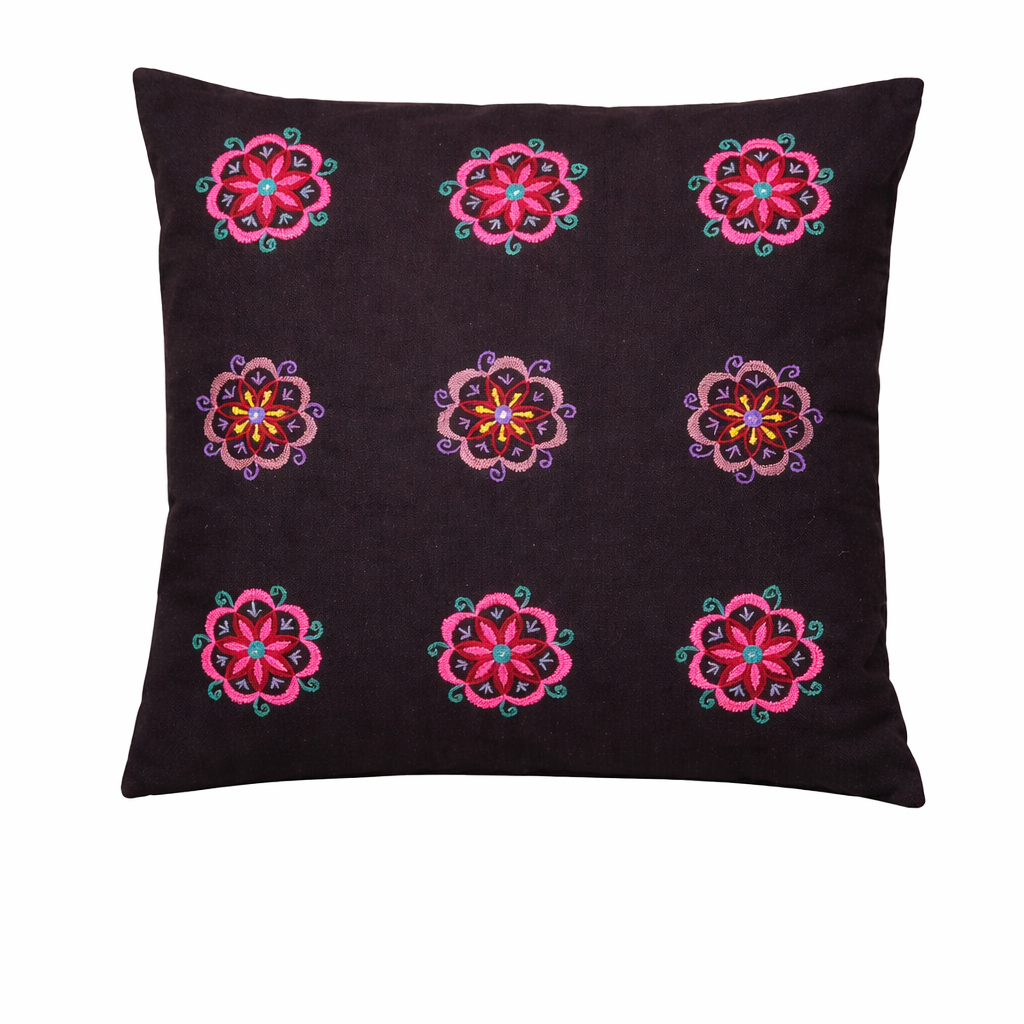 Black cushion cover featuring a symmetrical grid of nine embroidered floral motifs. Each flower is stitched in vibrant shades of pink, red, purple, teal, and yellow, creating a bright contrast against the dark fabric. The decorative folk-style embroidery gives the cushion a colourful, handcrafted look that adds warmth and character to home décor.