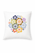White cushion cover featuring a circular arrangement of colourful embroidered flowers in shades of yellow, orange, blue, green, purple, and pink. The floral motifs form a cheerful bouquet-like design in the center, with simple decorative stitching and small accent shapes that give the cushion a fresh, playful, folk-inspired look.
