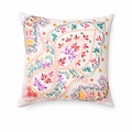 Decorative pillow with colorful paisley pattern on a white background. Made in India by women's fair trade collective.