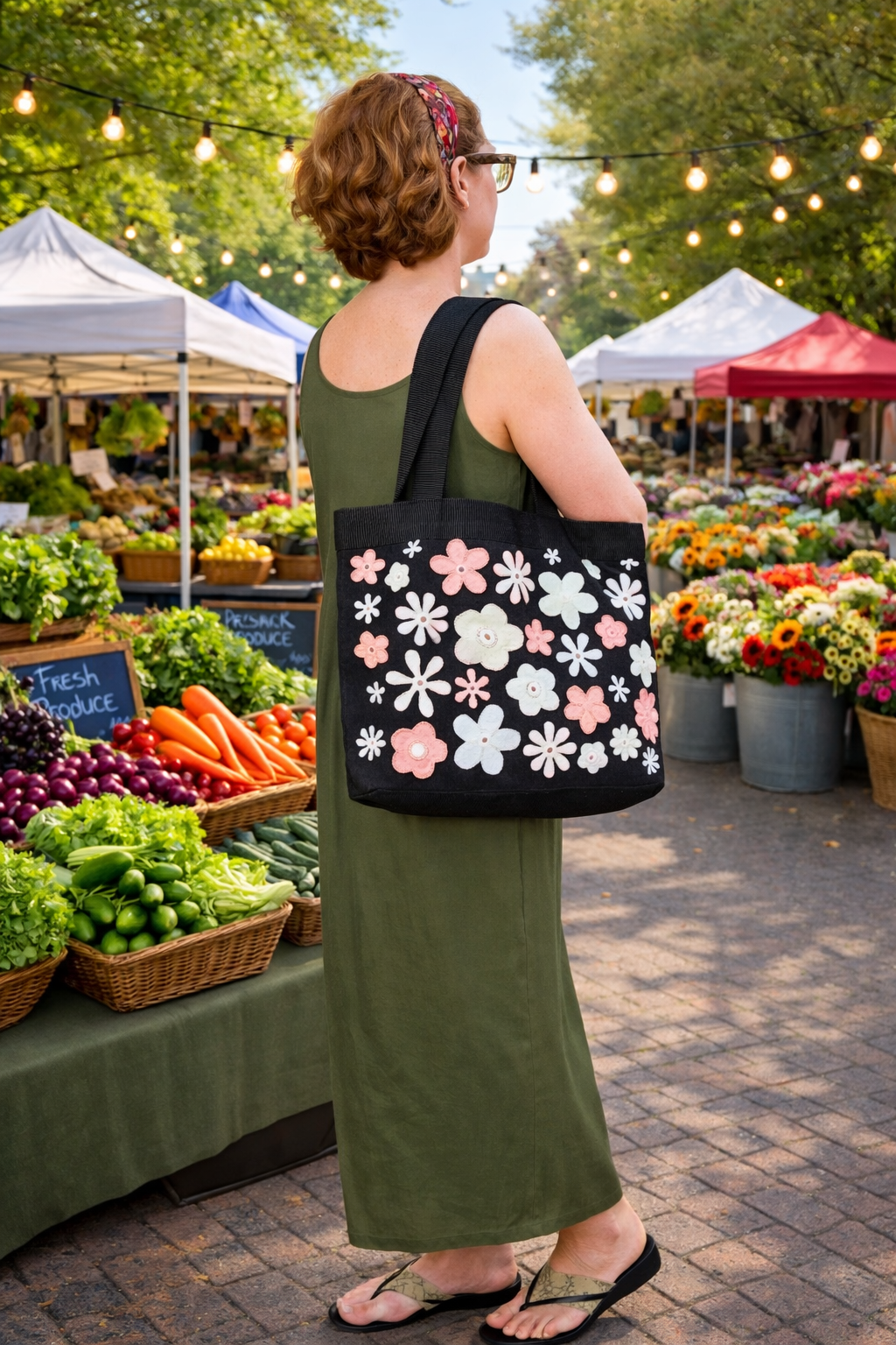 hand embroidered tote with attached purse. white and pink flowers on a black linen background. Made in India by a Women's fair trade collective.